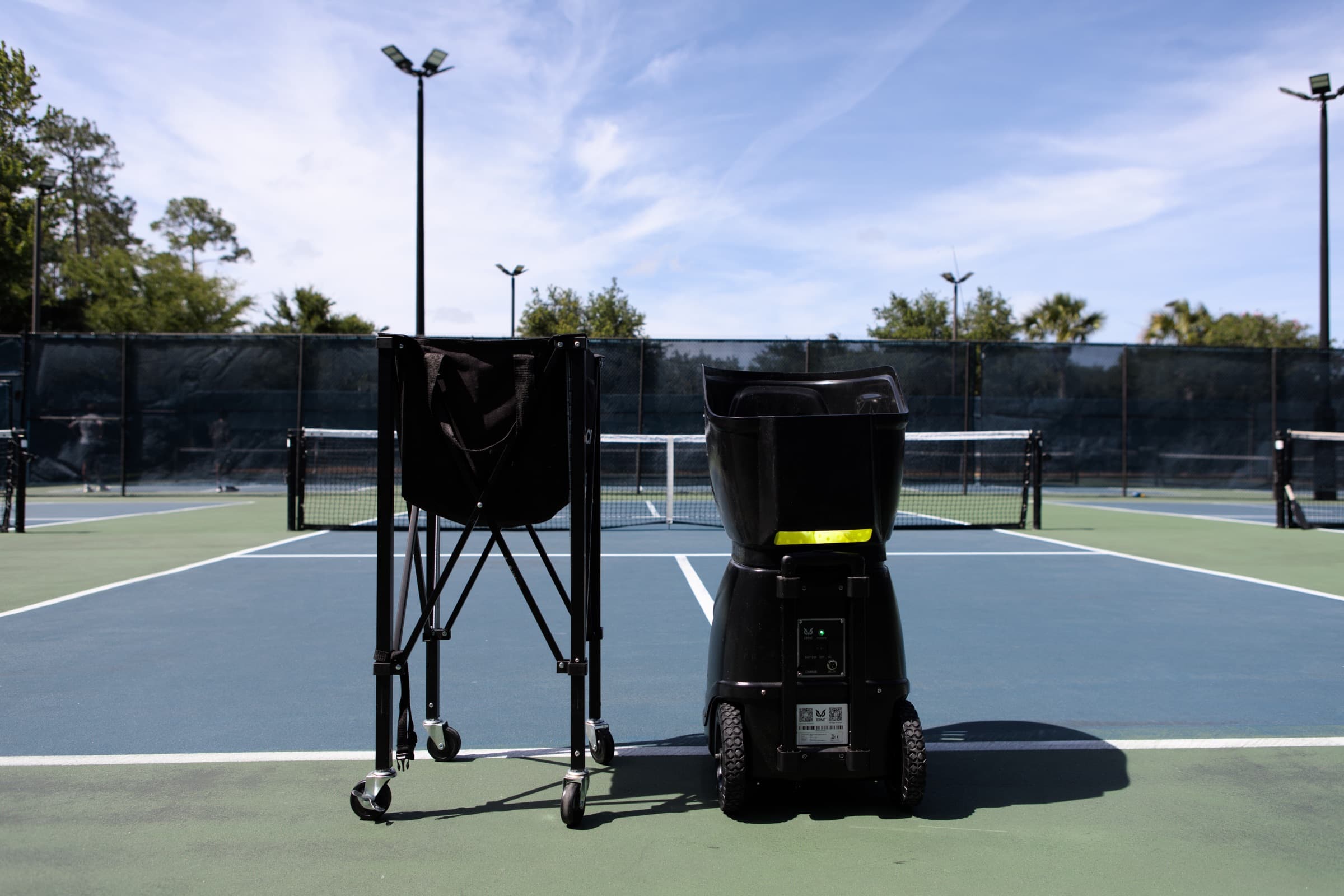 The ERNE pickleball machine and ball cart set up on the Palm Volley courts